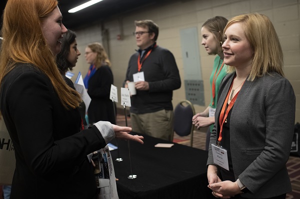 Lindsey Martin, assistant director of postdoctoral affairs at Northwestern Univ., speaks to an AHA19 attendee at the AHA Career Fair.
